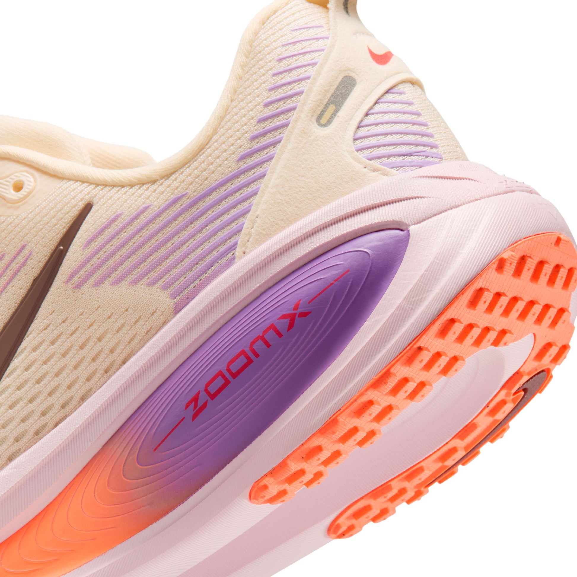 Close-up of a running shoe with 'zoom x' technology on a white background