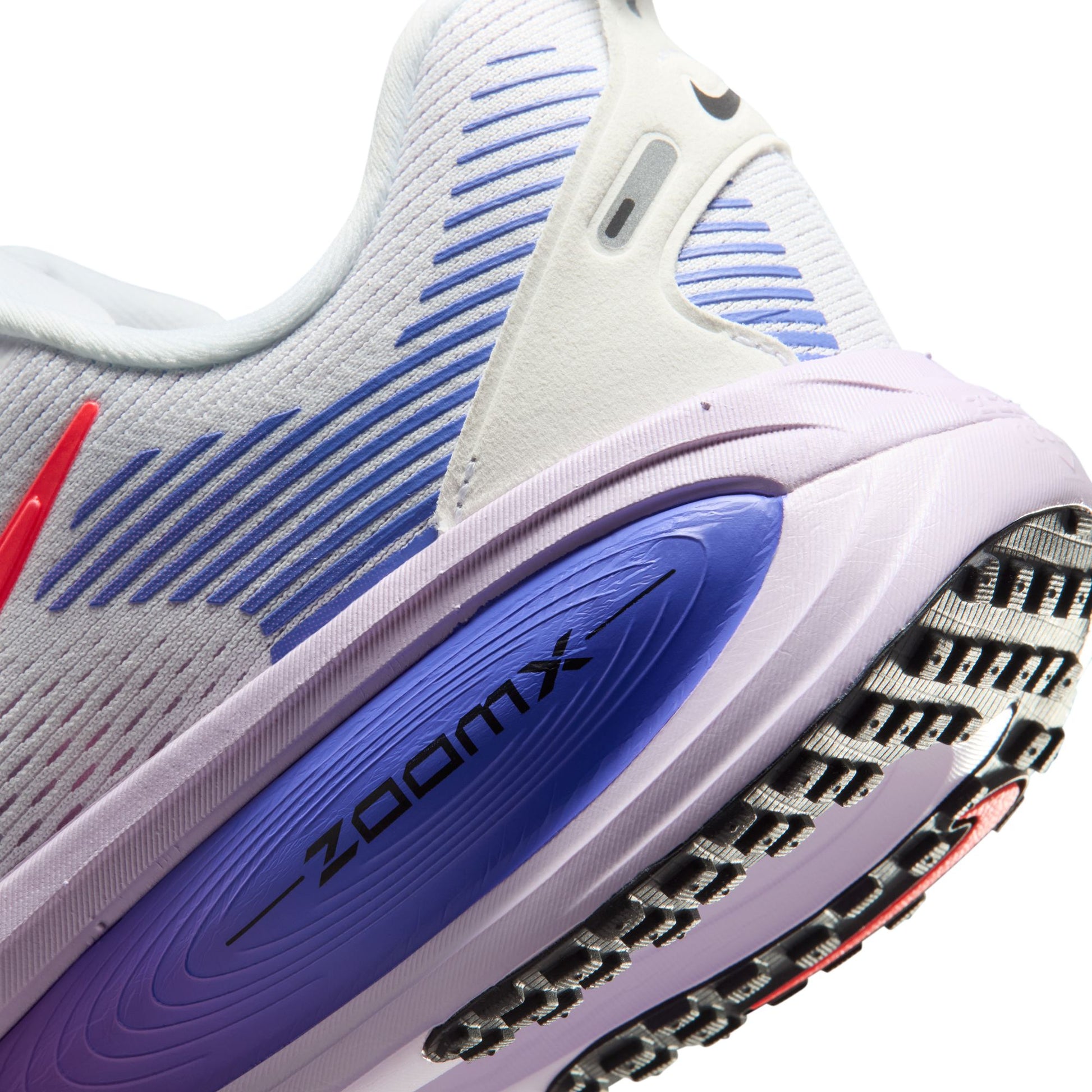 Close-up of a running shoe with purple sole and white body