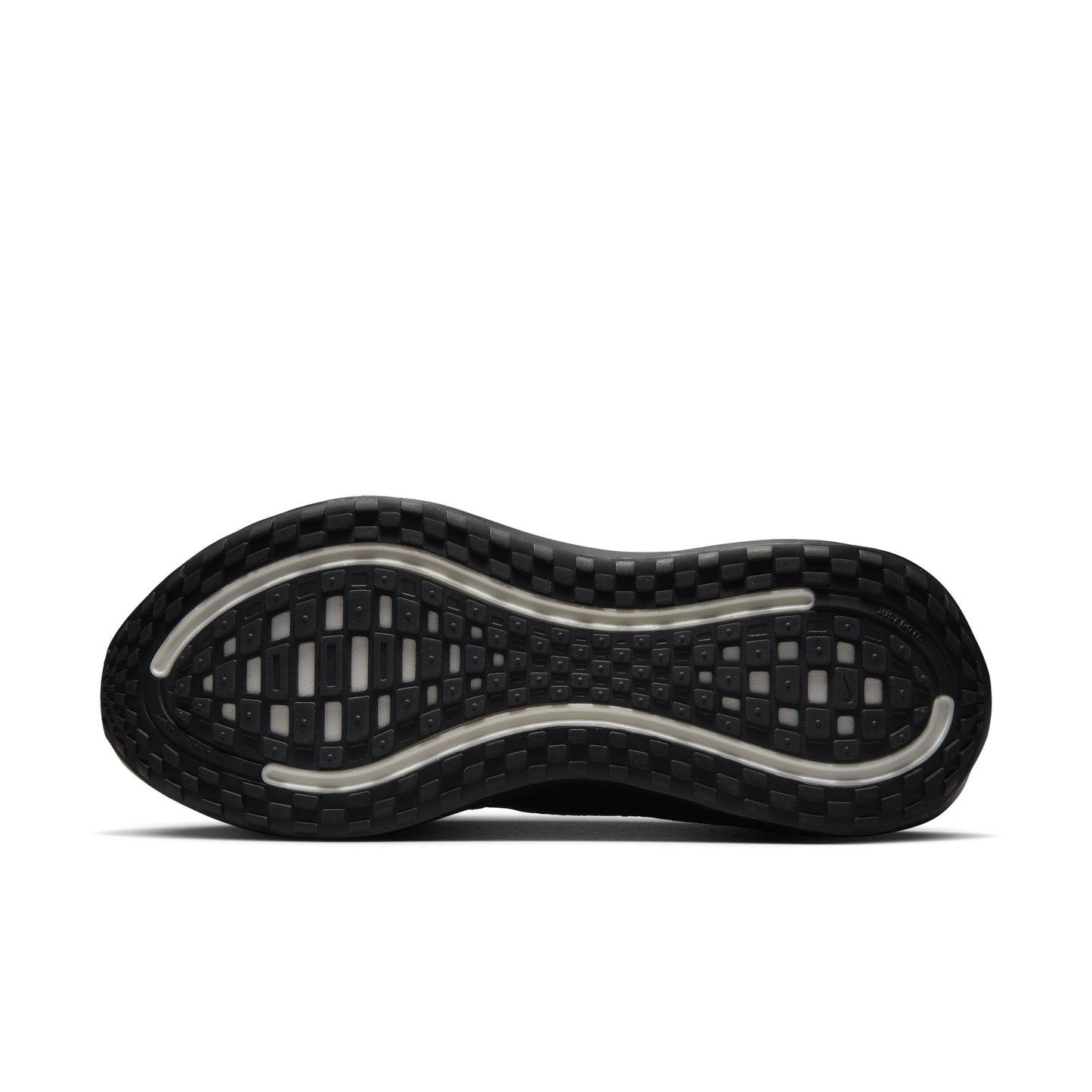Close-up of a black shoe sole with tread pattern on a white background