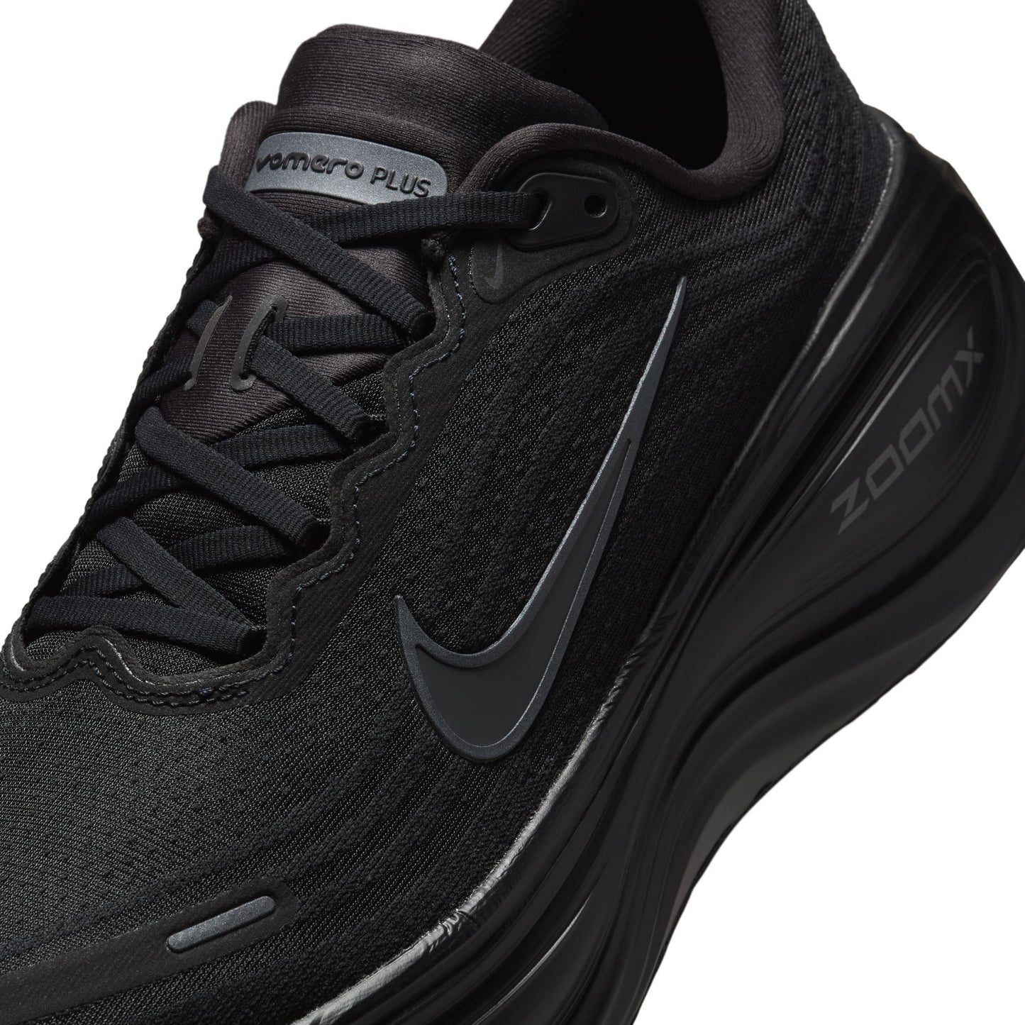 Black running shoe with Nike logo and 'Zoom' text on a white background