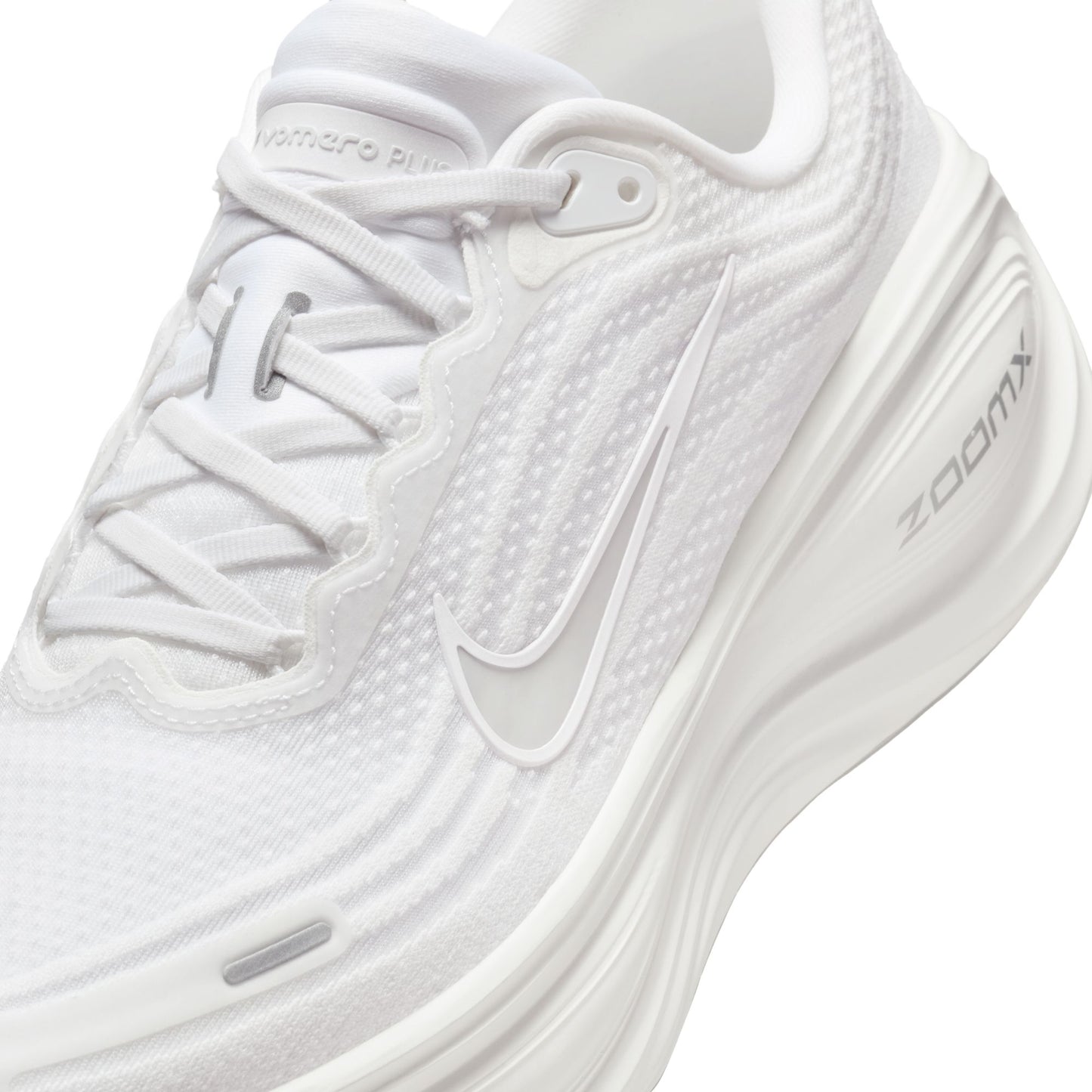 White running shoe with 'ZoomX' branding on a white background