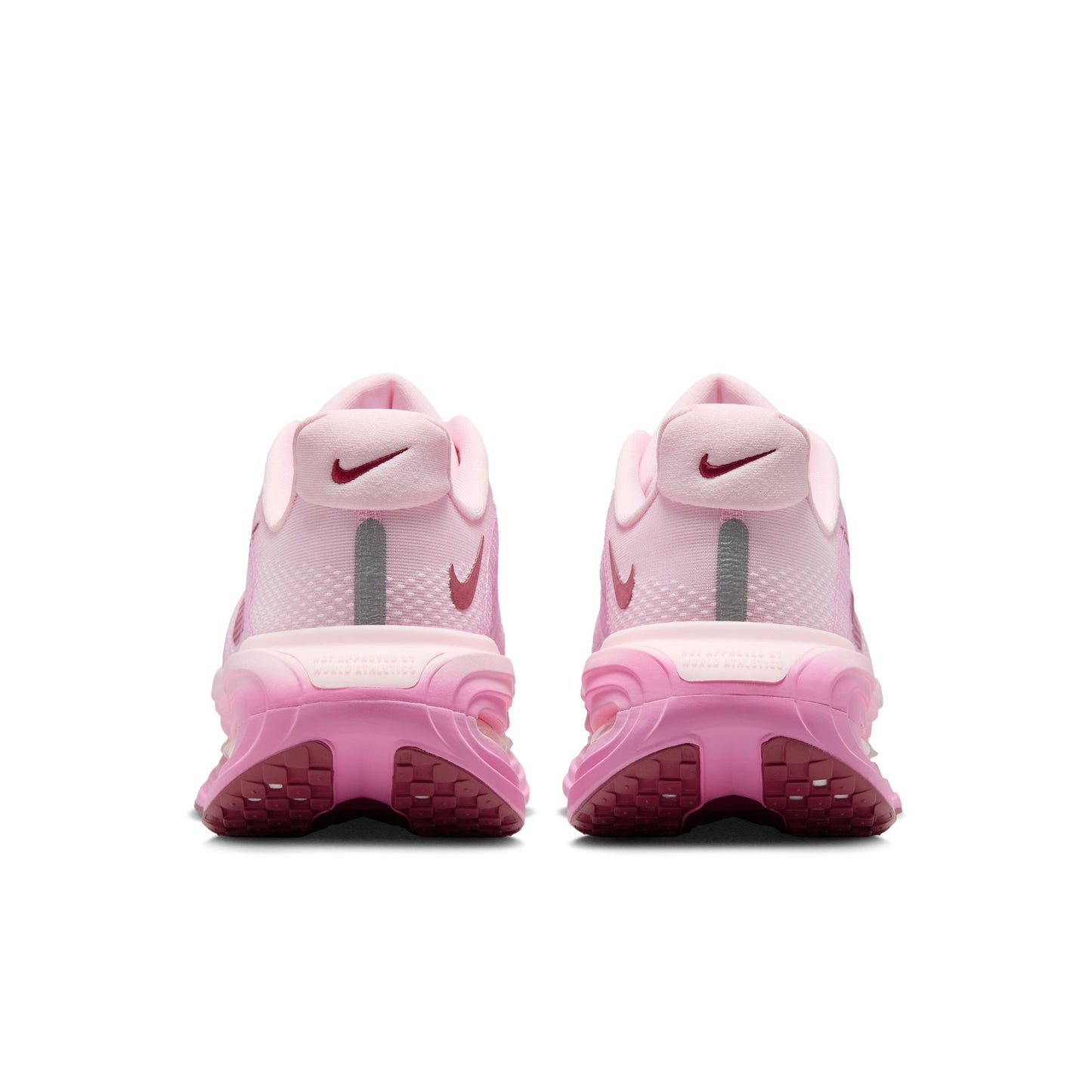 Pink Nike sneakers with a white background