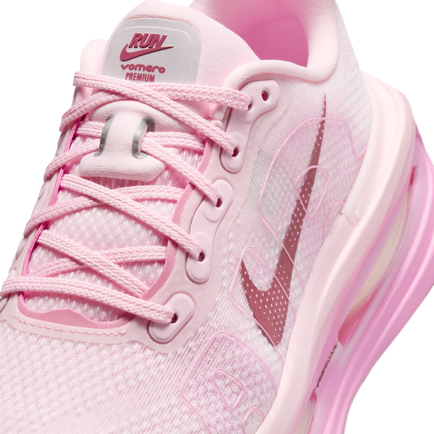 Pink running shoe with visible Nike logo on a white background