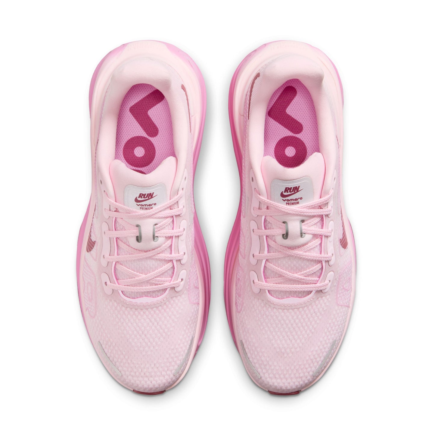 Pink running shoes with visible brand logo on a white background