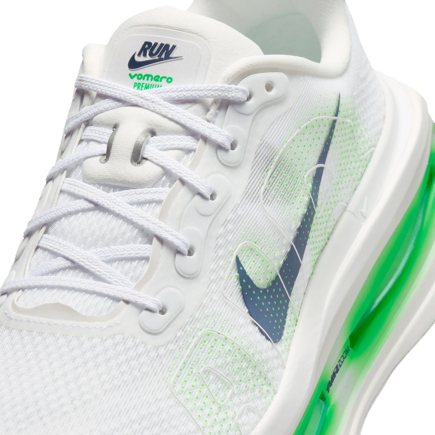 White running shoe with green accents and Nike logo on a white background