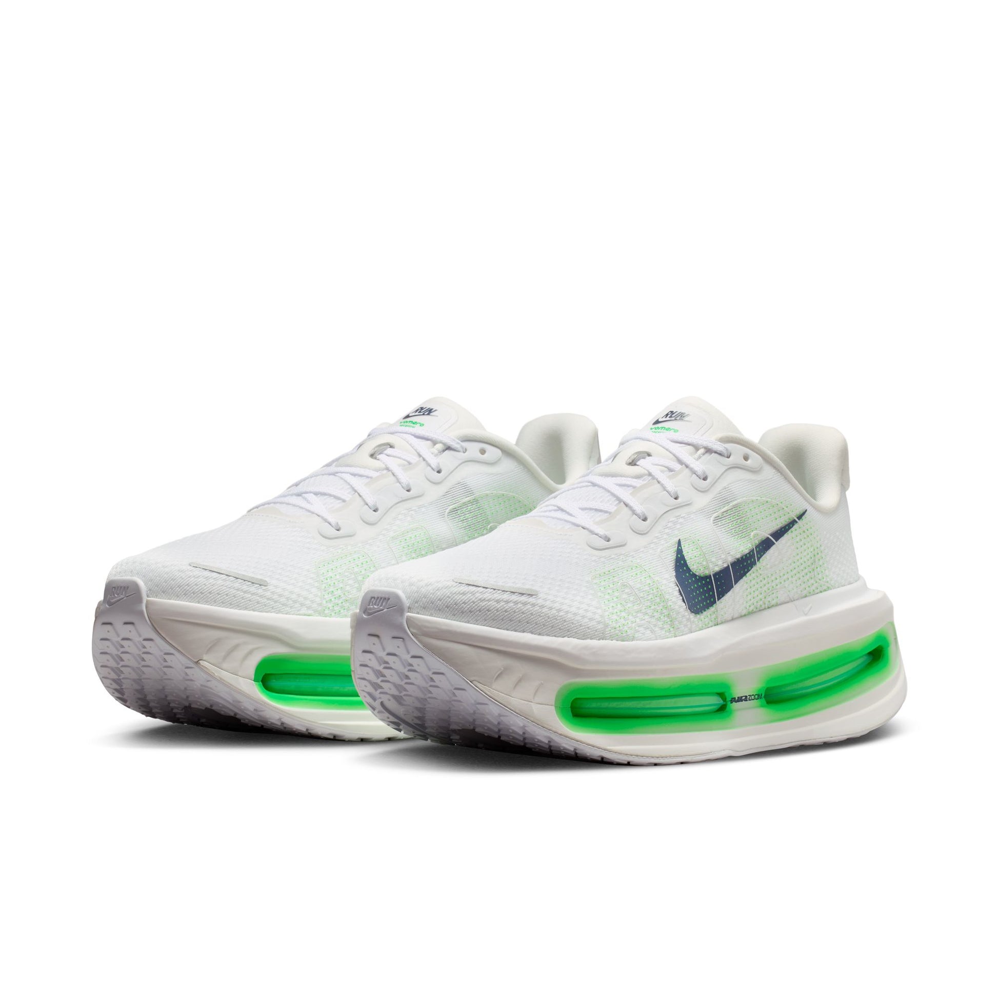 White sneakers with green accents on a white background