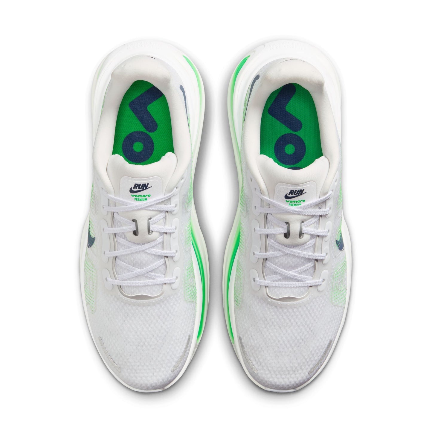 White sneakers with green accents on a white background