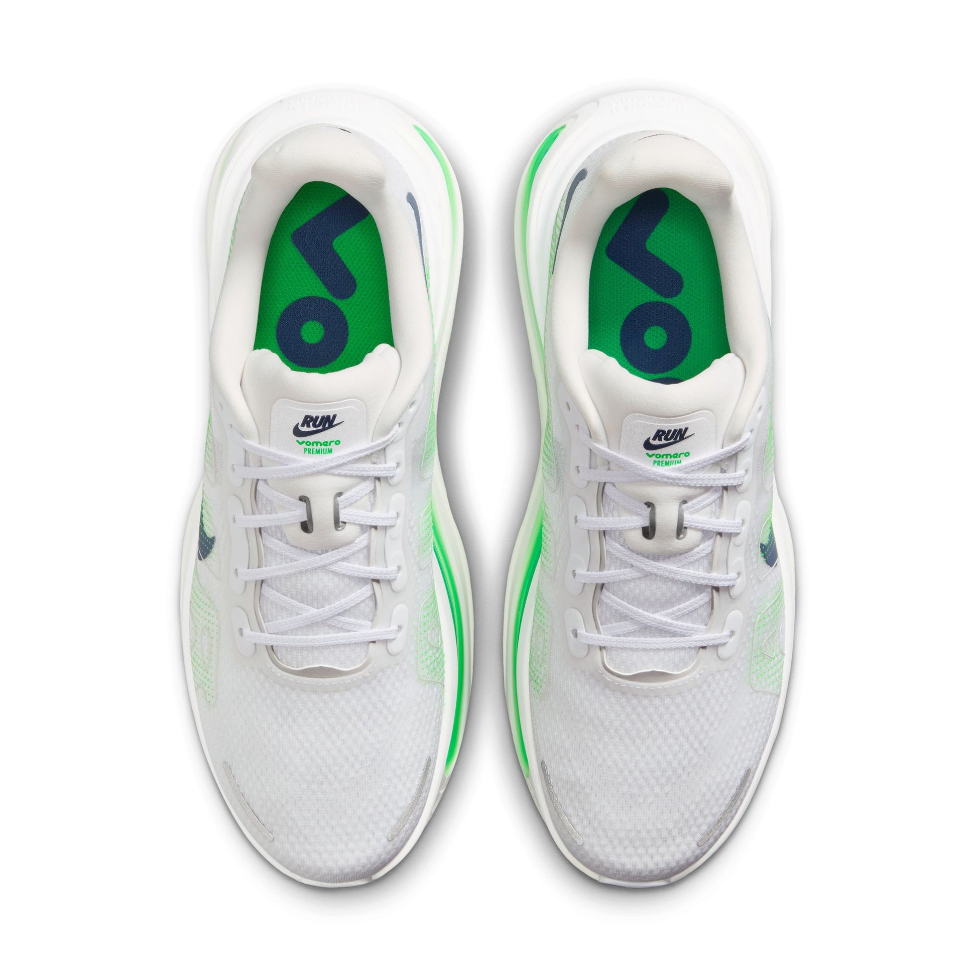 White sneakers with green accents on a white background