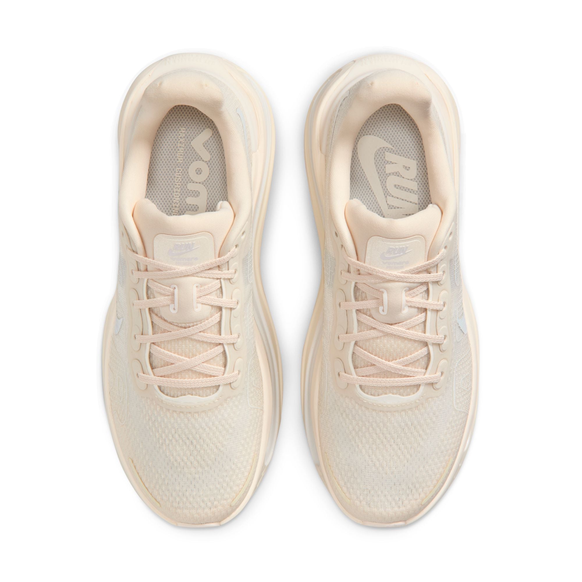 Pair of beige running shoes on a white background