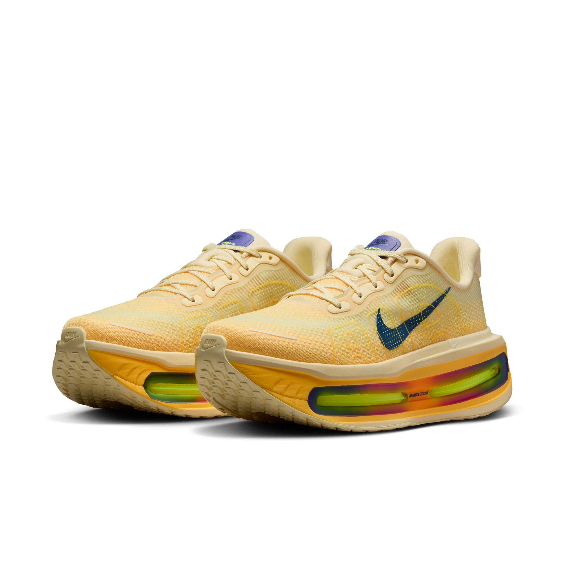 Pair of yellow sneakers with visible Nike logo on a white background