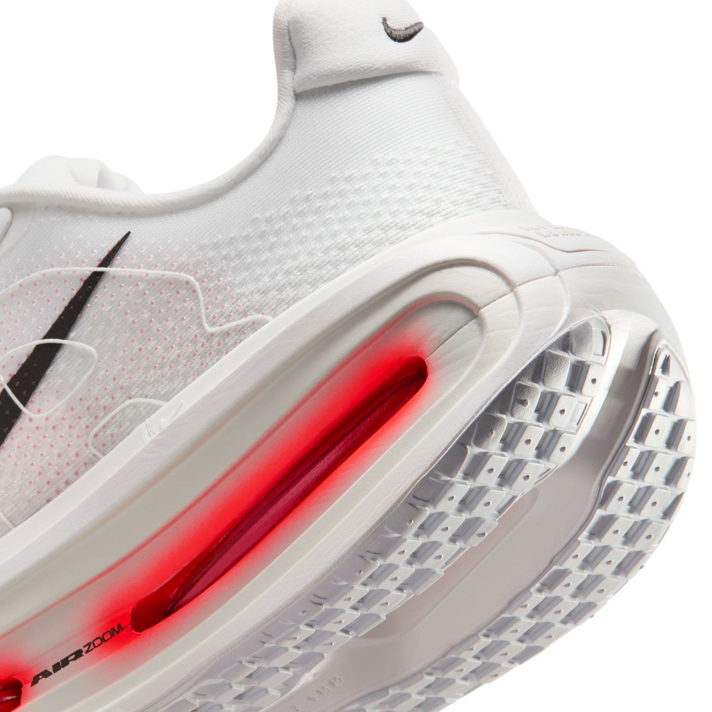 Close-up of a white sneaker with red air unit on a white background