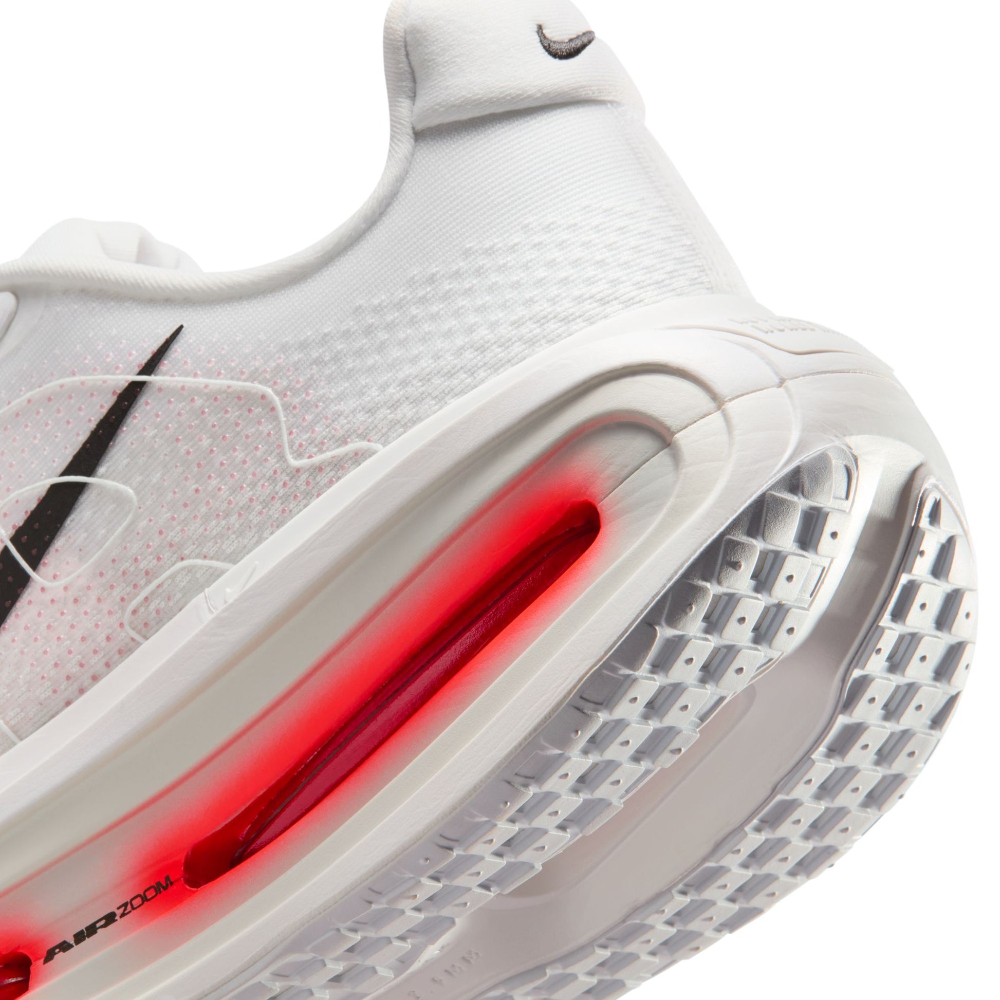 Close-up of a white sneaker with red air unit on a white background
