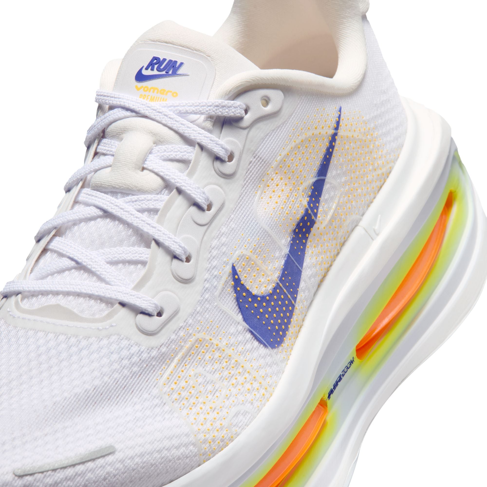 White shoe with blue, yellow orange accents on white background