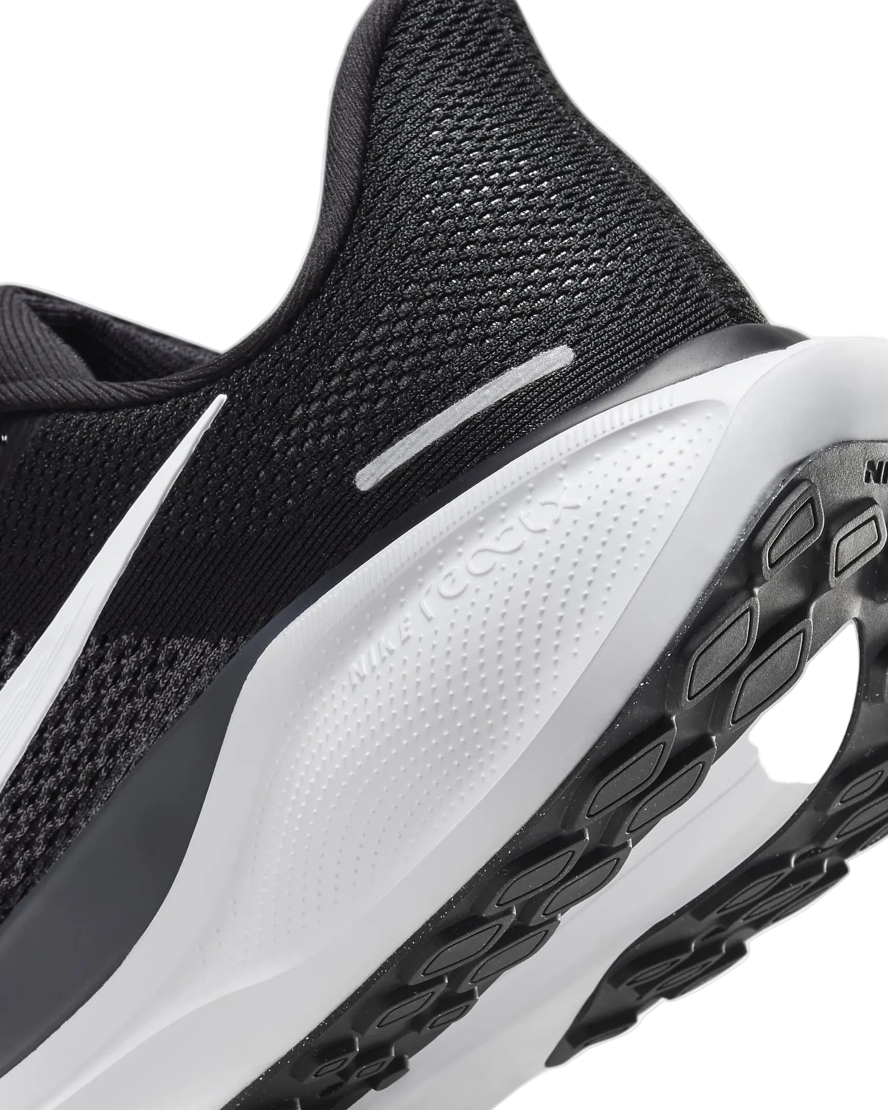 Close-up of a black and white athletic shoe with a focus on the sole.