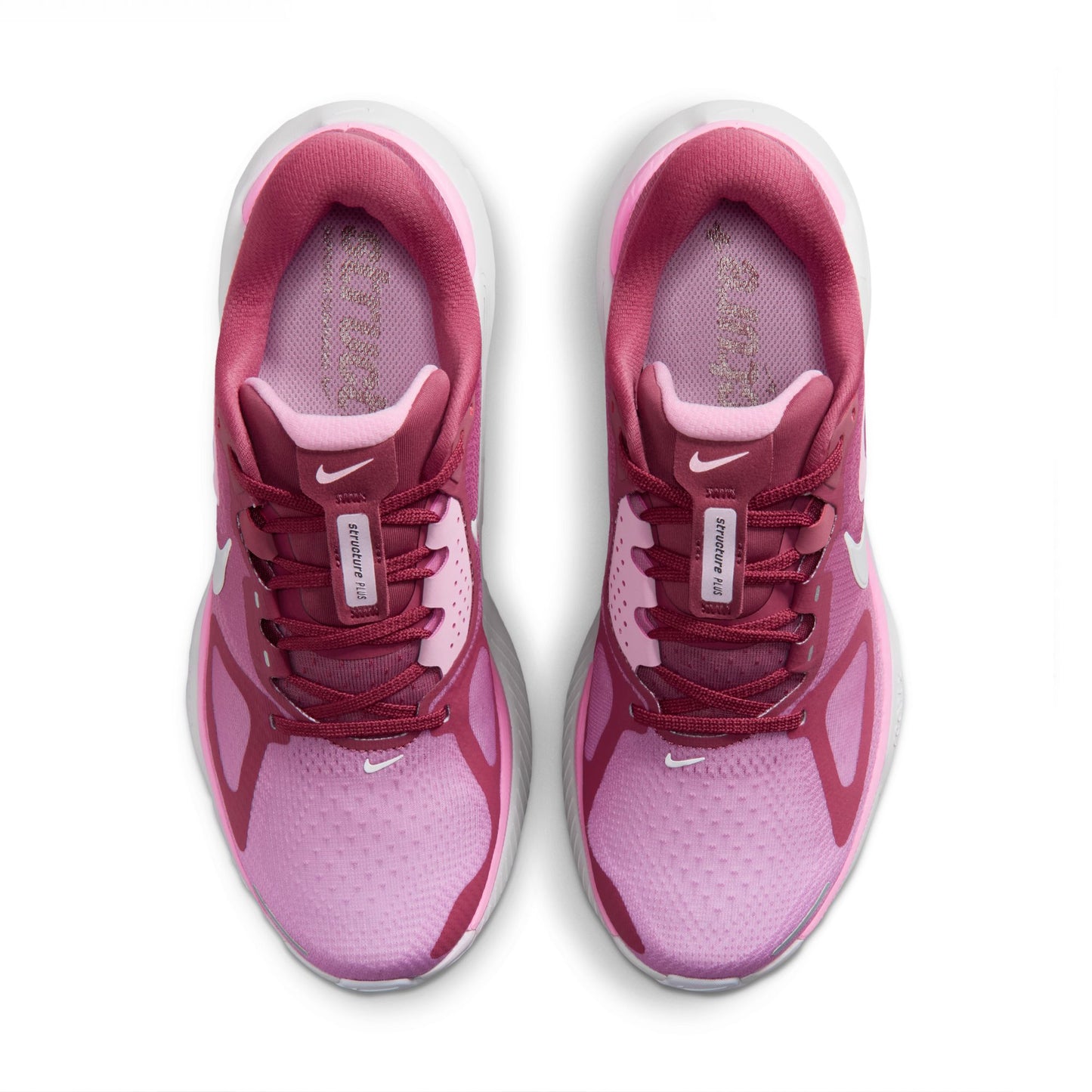 Pink and white running shoes with Nike logo on a white background