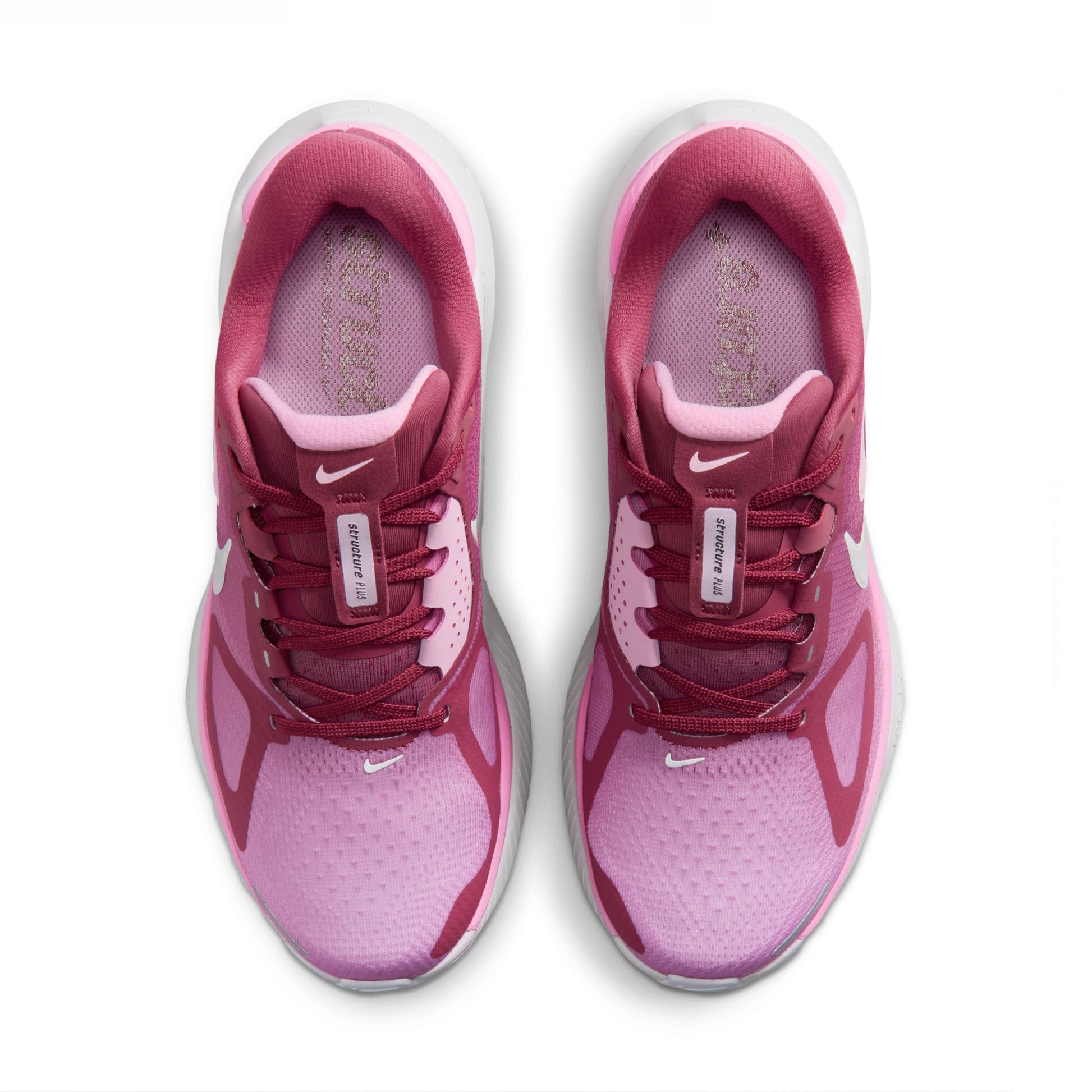 Pink and white running shoes with Nike logo on a white background