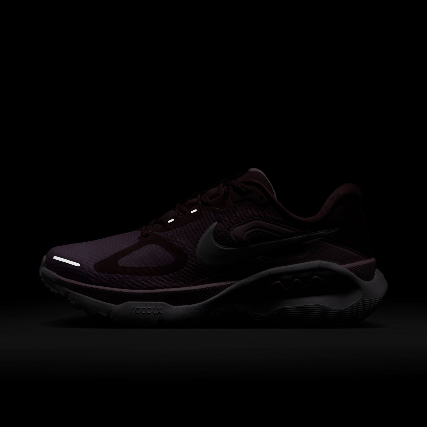Black sneaker with reflective elements on a black background