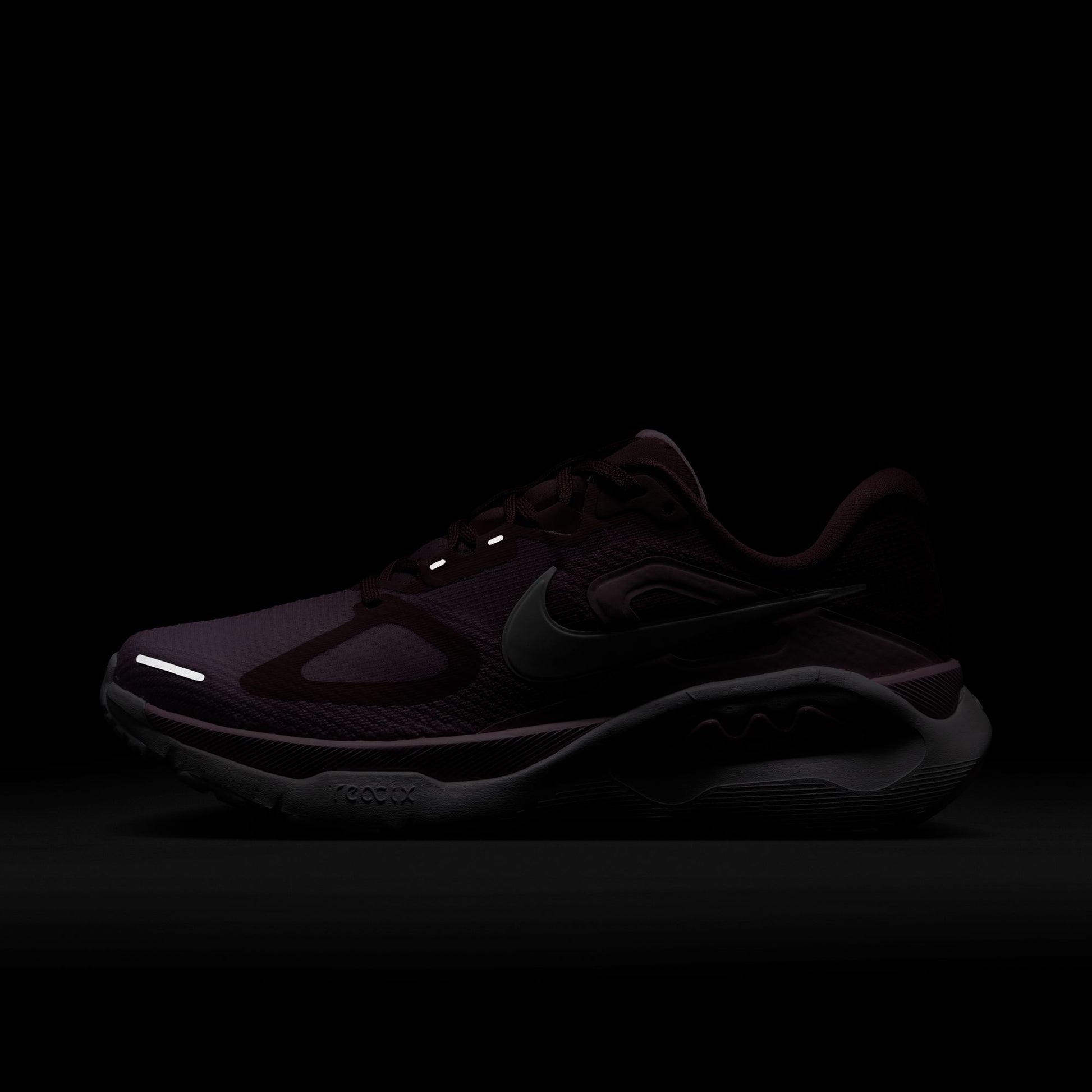 Black sneaker with reflective elements on a black background