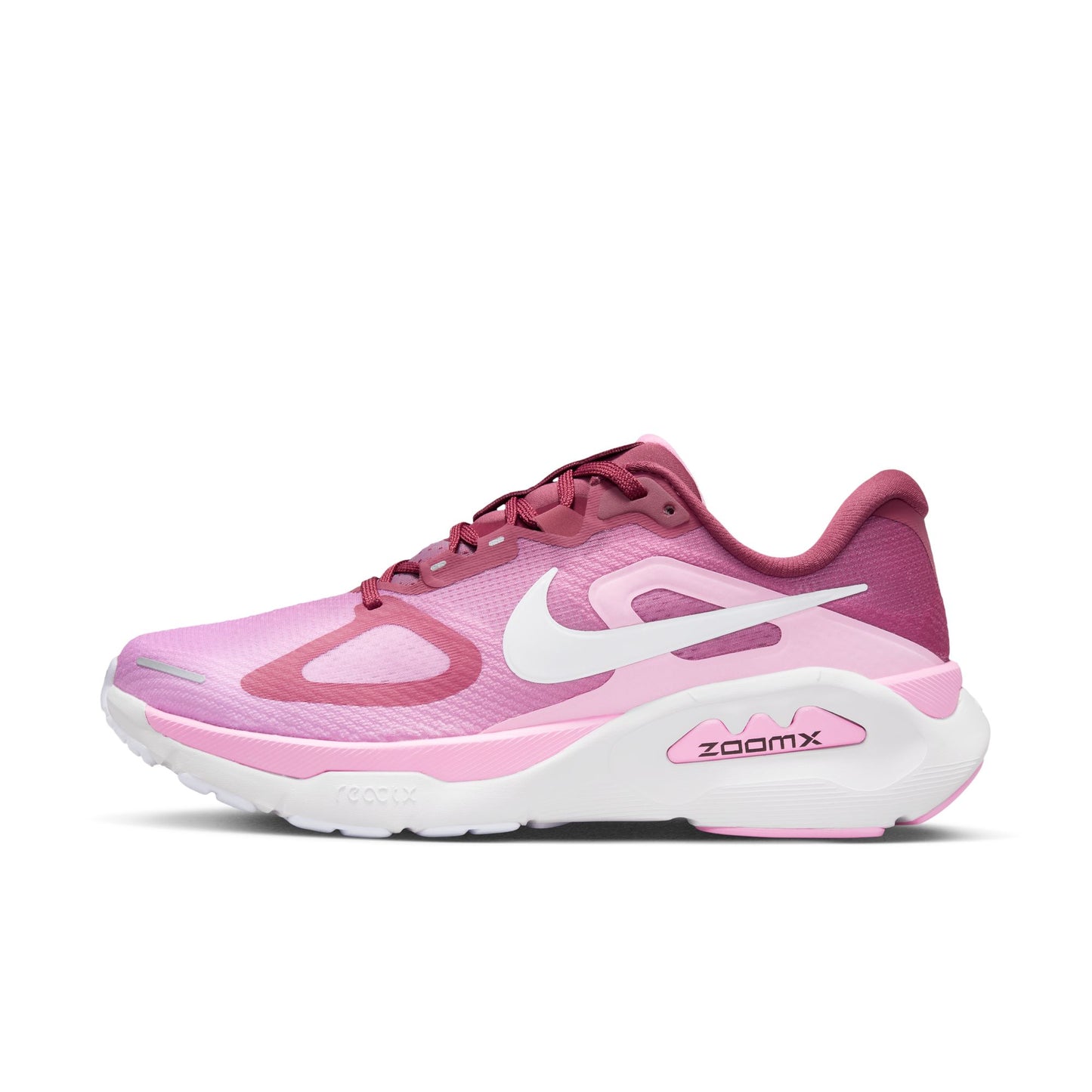 Pink and white running shoe with 'zoomx' on a white background