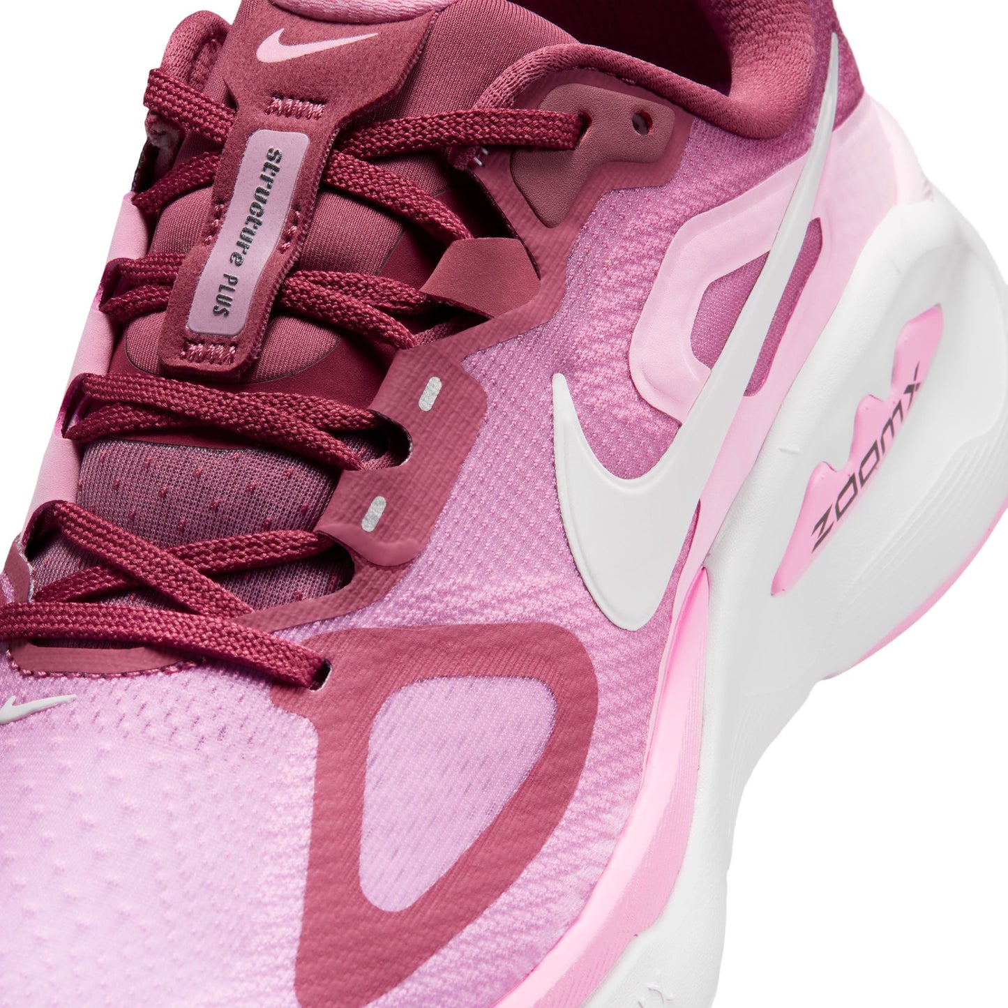 Pink and white sneaker with Nike logo on a white background