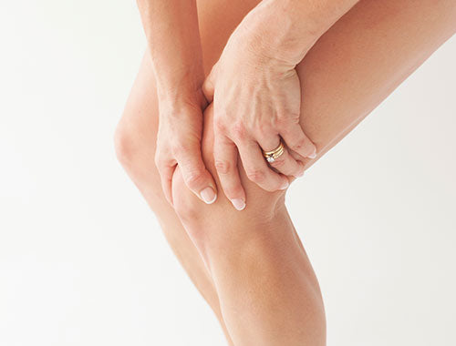 Sore knee with hands grabbing in high resolution