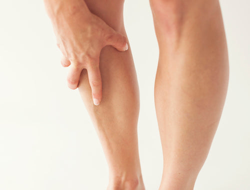 Picture of person with hand on sore shin in high resolution