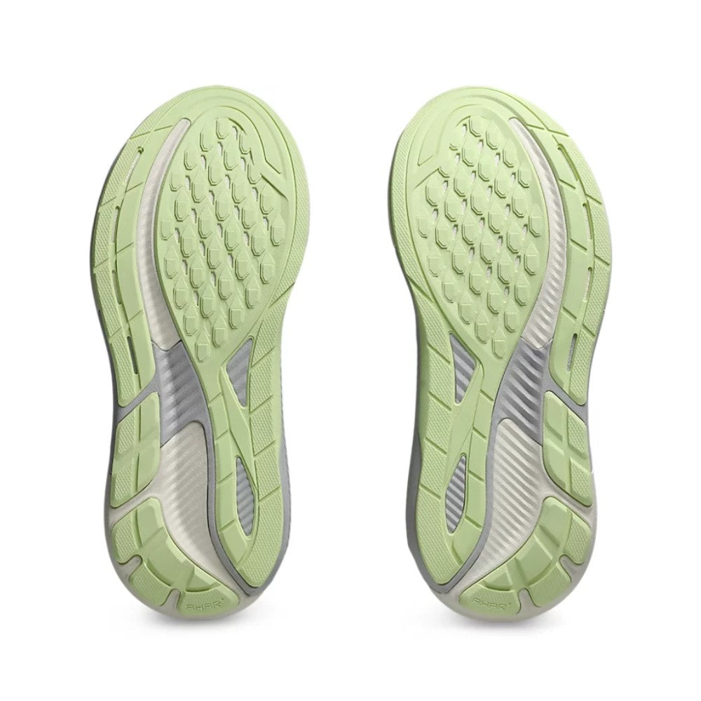 Light green running shoes with tread pattern on a white background