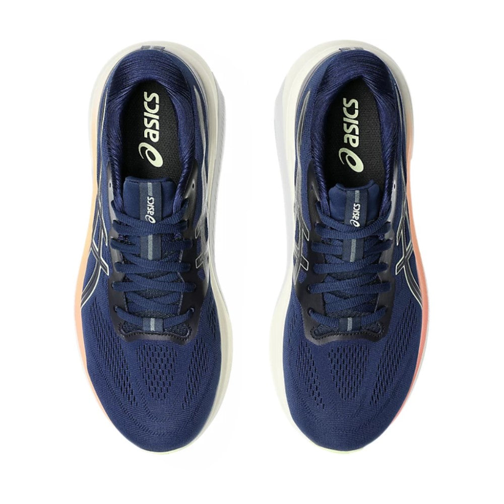 Pair of blue running shoes with white soles on a white background